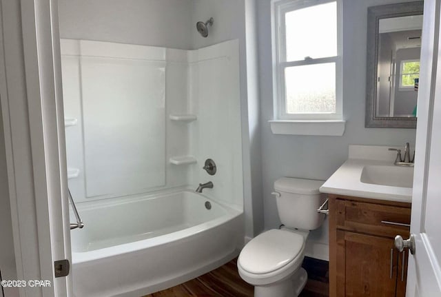 full bathroom with vanity, hardwood / wood-style flooring, shower / bathing tub combination, and toilet