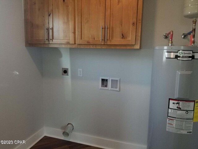 laundry room with cabinets, electric water heater, hookup for a washing machine, dark hardwood / wood-style floors, and hookup for an electric dryer