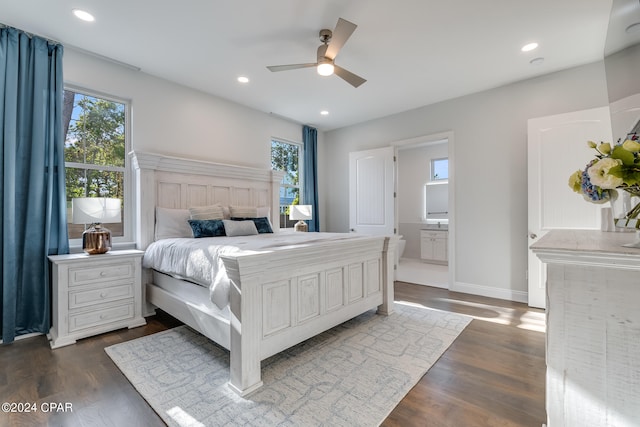 bedroom with ensuite bath, ceiling fan, and dark hardwood / wood-style flooring