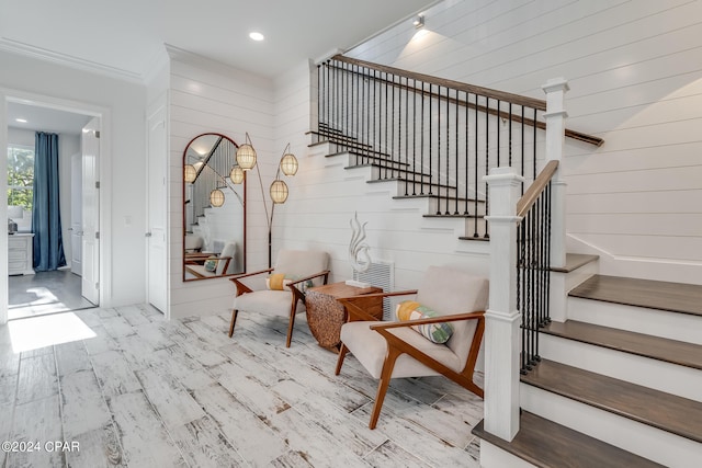 stairway featuring wood-type flooring and wood walls