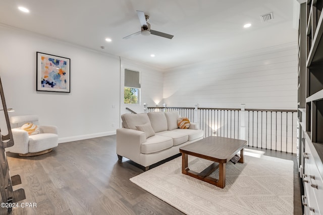 living room featuring crown molding, dark wood-type flooring, and ceiling fan