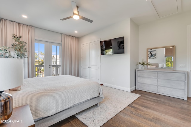 bedroom featuring french doors, ceiling fan, access to exterior, hardwood / wood-style flooring, and a closet