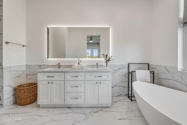 bathroom featuring tile flooring, tile walls, and dual bowl vanity