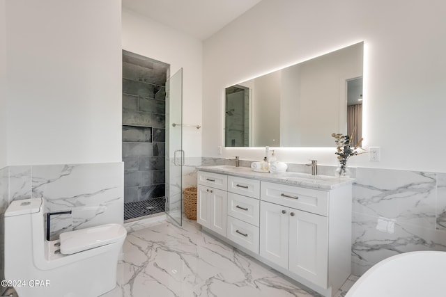 bathroom featuring tile walls, a shower with shower door, toilet, double vanity, and tile flooring