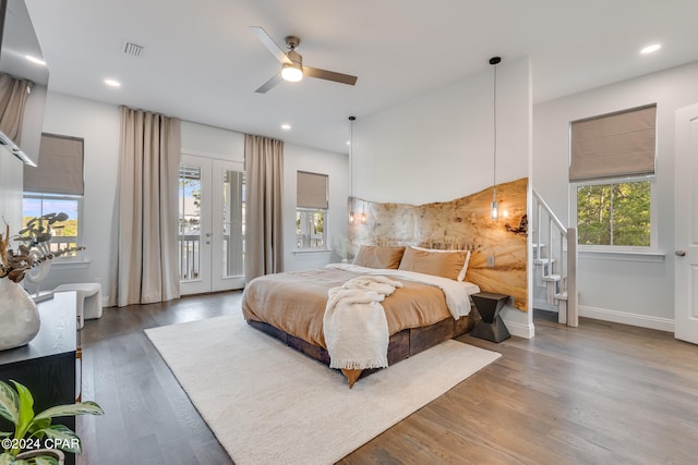 bedroom featuring ceiling fan, french doors, dark wood-type flooring, and access to outside