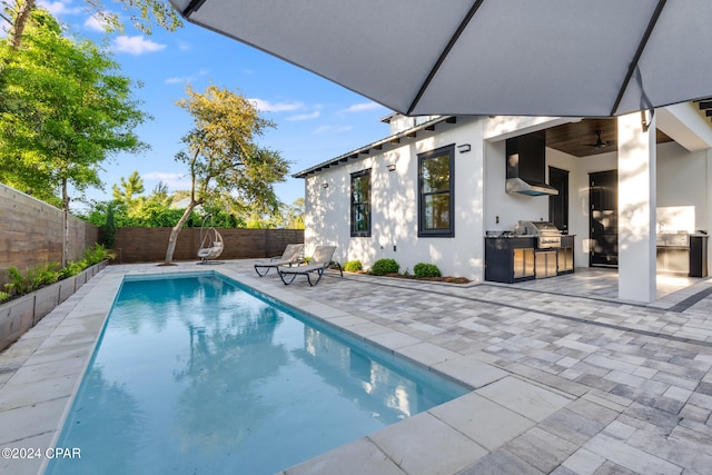 view of pool with a grill, ceiling fan, and a patio area