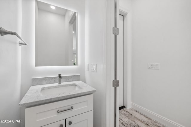 bathroom with vanity and hardwood / wood-style flooring