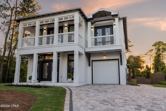 view of front facade with a balcony and a garage