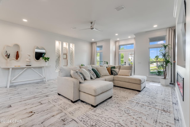 living room featuring light hardwood / wood-style flooring, french doors, and ceiling fan