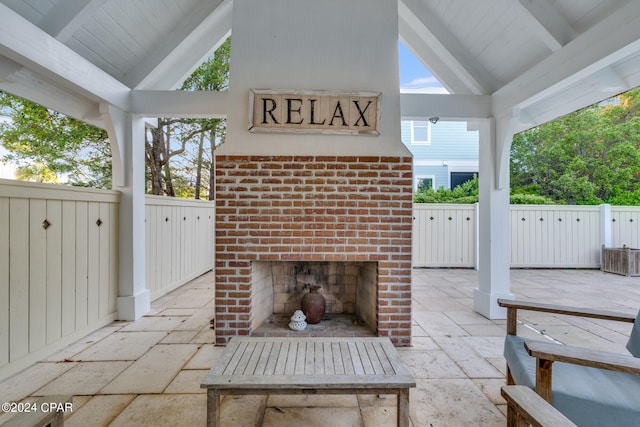 view of patio / terrace with an outdoor brick fireplace