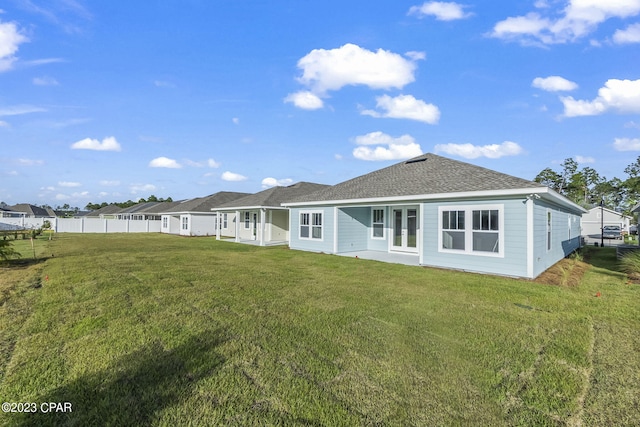 rear view of property featuring a yard