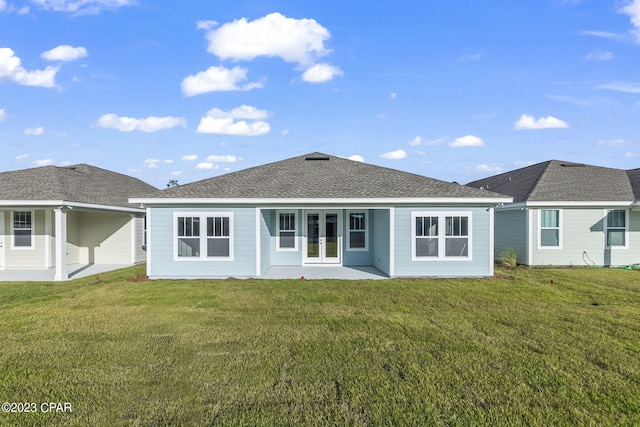 back of property featuring french doors, a yard, and a patio