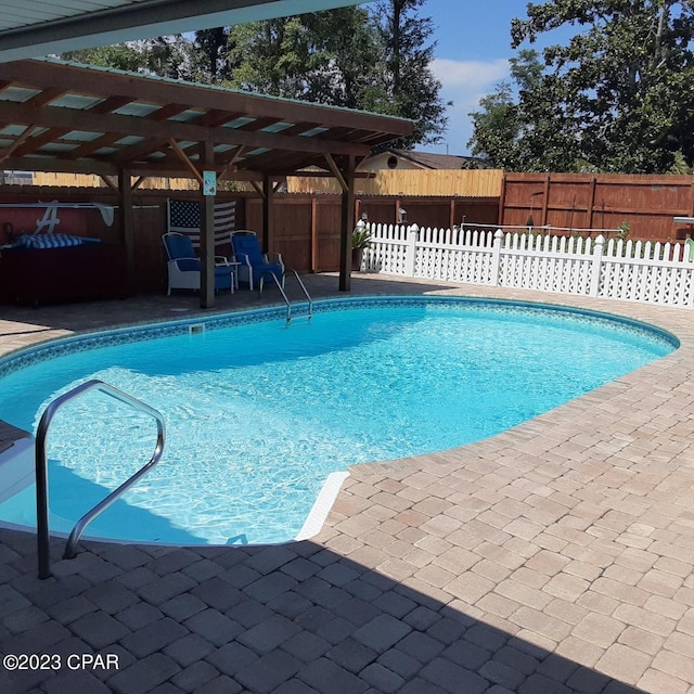 view of pool with a pergola and a patio