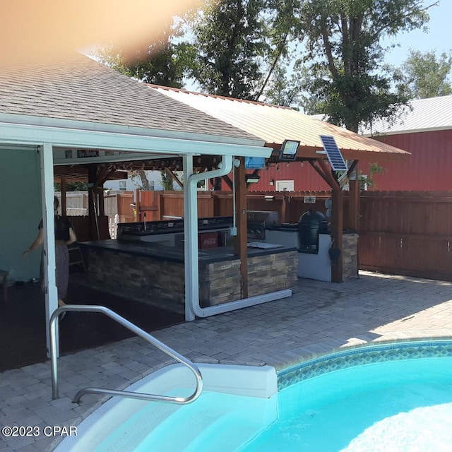 view of pool with a patio and area for grilling