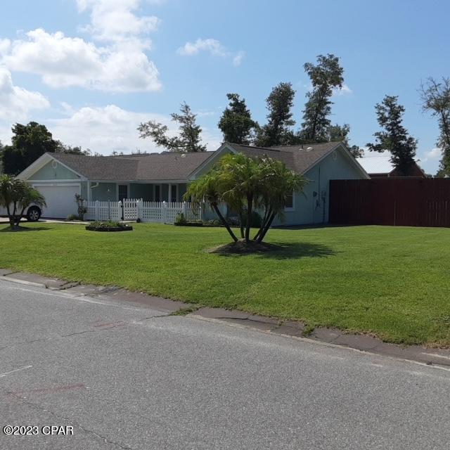 view of front facade with a front yard and a garage