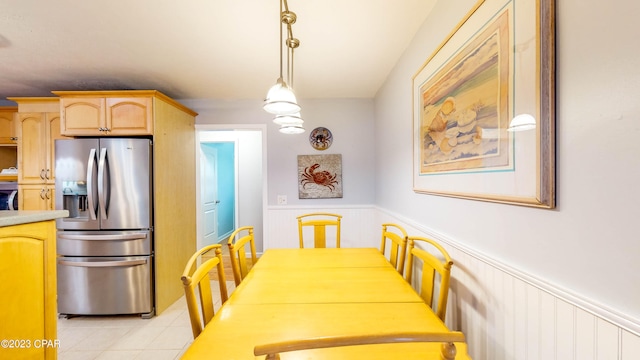 dining area featuring light tile flooring and a notable chandelier