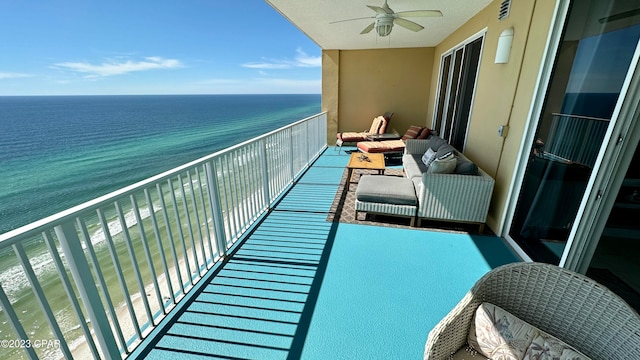 balcony featuring a water view and ceiling fan