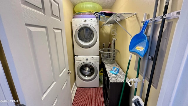 washroom with stacked washer / drying machine