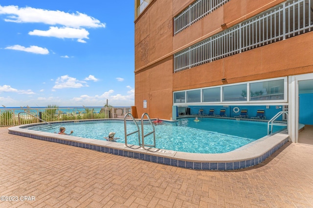 view of swimming pool with a patio