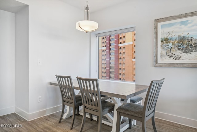 dining area featuring dark wood-type flooring