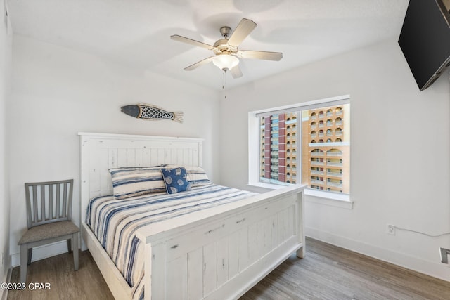 bedroom with hardwood / wood-style floors and ceiling fan