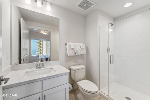 bathroom with toilet, ceiling fan, vanity with extensive cabinet space, an enclosed shower, and tile flooring