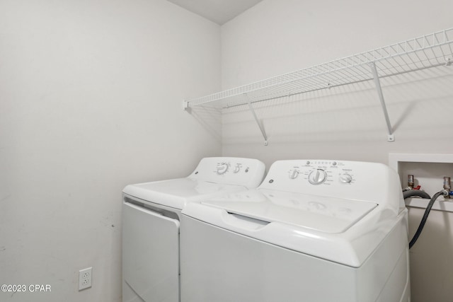 clothes washing area featuring hookup for a washing machine and separate washer and dryer