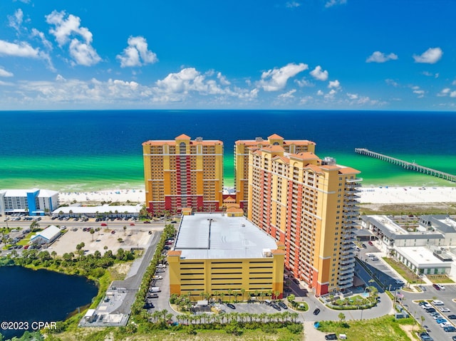 bird's eye view featuring a water view and a beach view