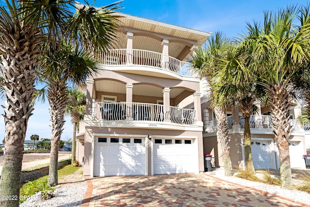 coastal home featuring a balcony and a garage