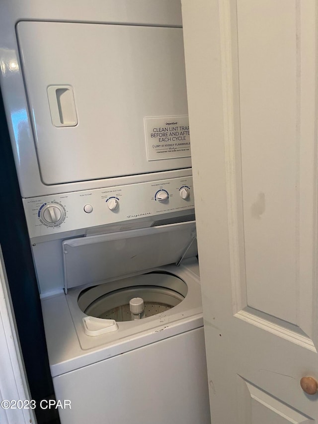 laundry room with stacked washing maching and dryer