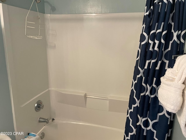 bathroom with shower / bathtub combination with curtain