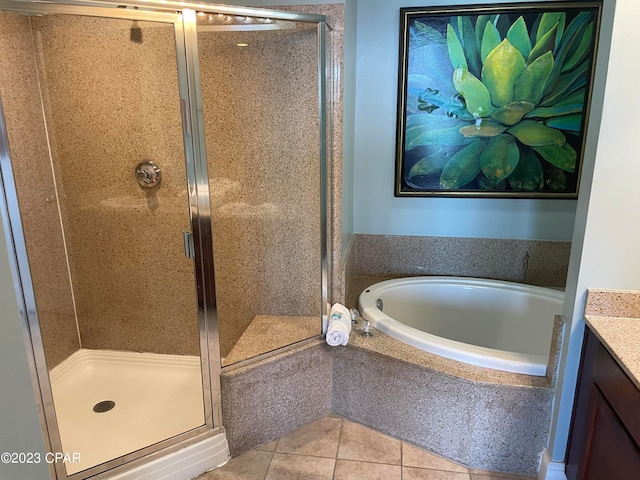 bathroom featuring independent shower and bath, vanity, and tile patterned floors