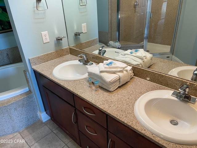 bathroom featuring independent shower and bath, tile patterned flooring, and vanity