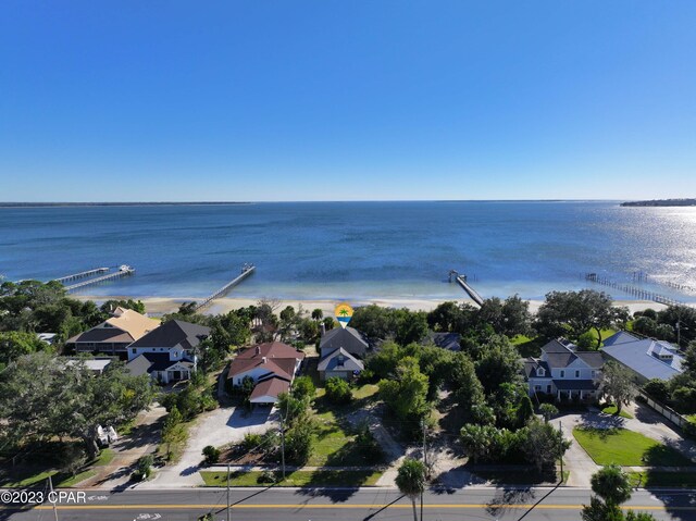 drone / aerial view with a beach view and a water view