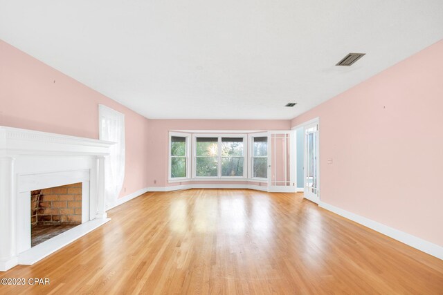 unfurnished living room with light hardwood / wood-style flooring