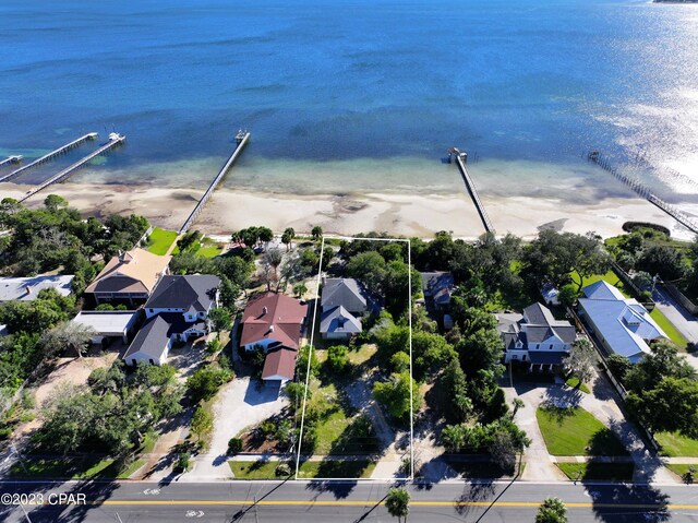 drone / aerial view with a water view and a view of the beach