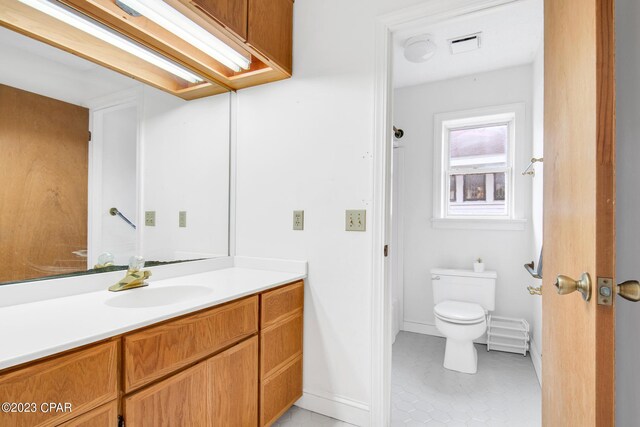 bathroom featuring vanity and toilet