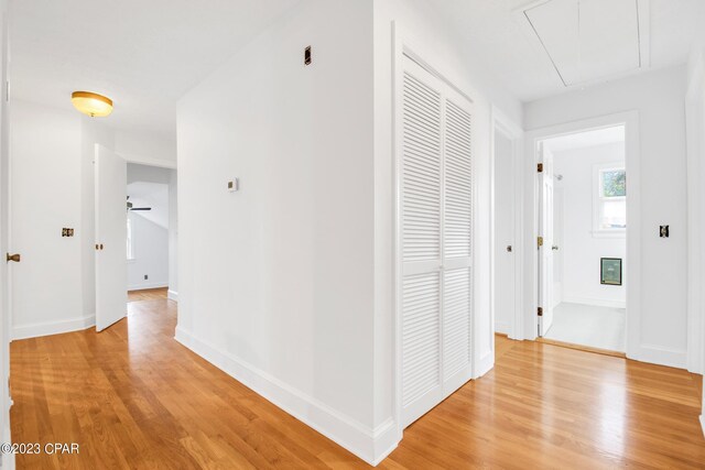 corridor with light hardwood / wood-style floors