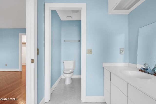 bathroom featuring vanity, tile patterned floors, and toilet