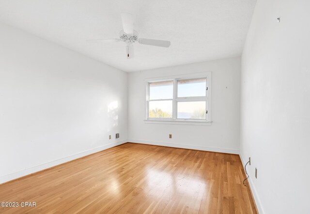 unfurnished room featuring ceiling fan and light wood-type flooring