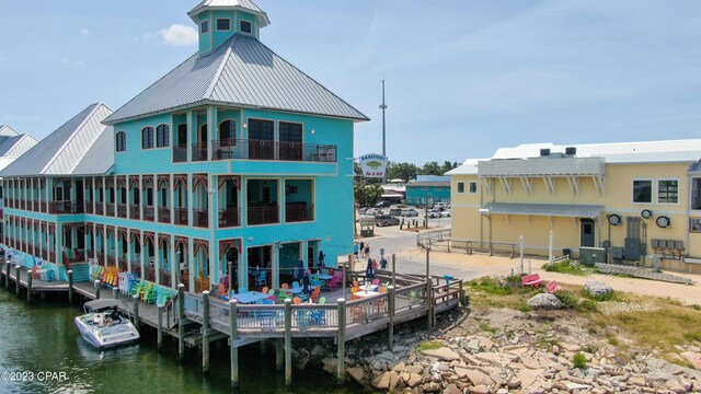 rear view of house featuring a water view and cooling unit