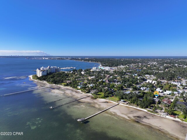 birds eye view of property with a water view and a beach view