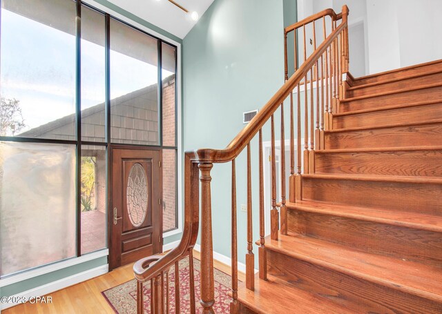 foyer entrance with hardwood / wood-style flooring and floor to ceiling windows