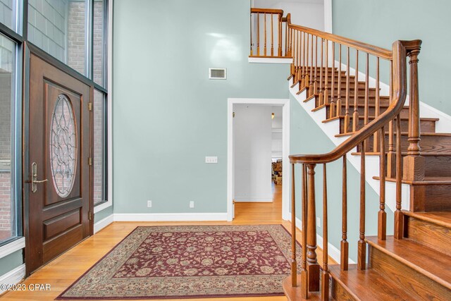 entrance foyer featuring hardwood / wood-style floors and a high ceiling