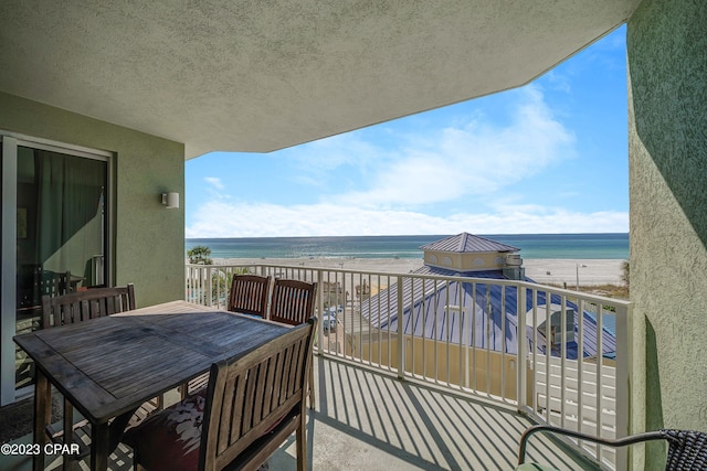 balcony with a view of the beach and a water view