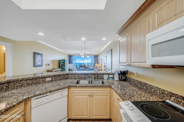 kitchen featuring white appliances, ceiling fan, light brown cabinetry, and sink