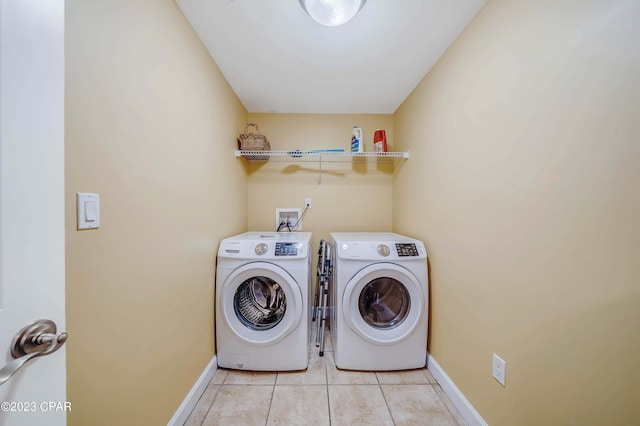 laundry room featuring separate washer and dryer and light tile patterned floors