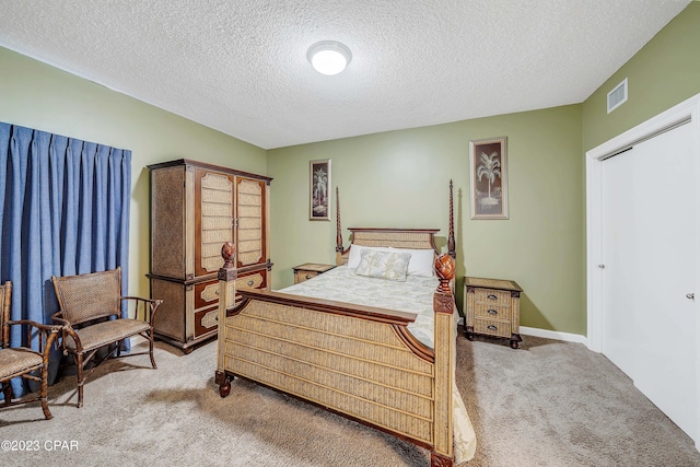 bedroom with carpet and a textured ceiling