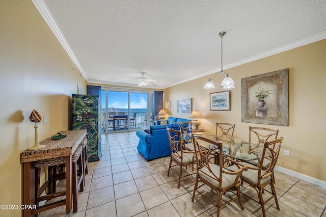 dining space with a textured ceiling, ceiling fan with notable chandelier, crown molding, and light tile patterned floors