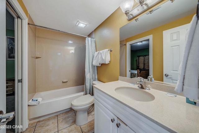 full bathroom featuring vanity, shower / bath combo with shower curtain, toilet, and tile patterned flooring